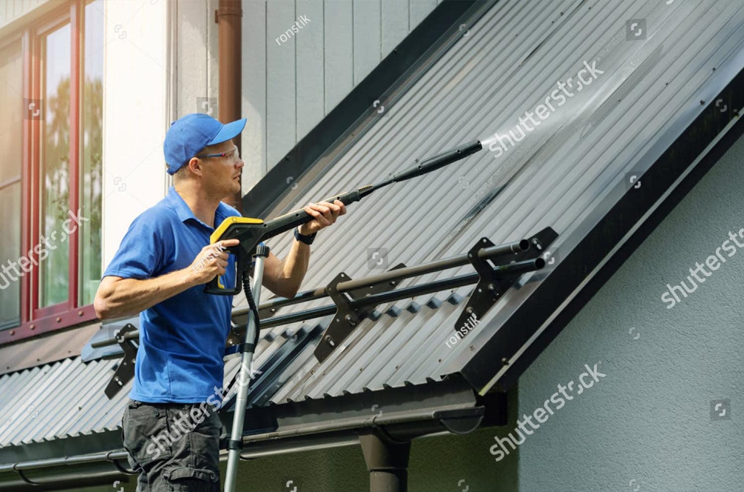 stock photo man installing house roof rain gutter system 1324945004 copy